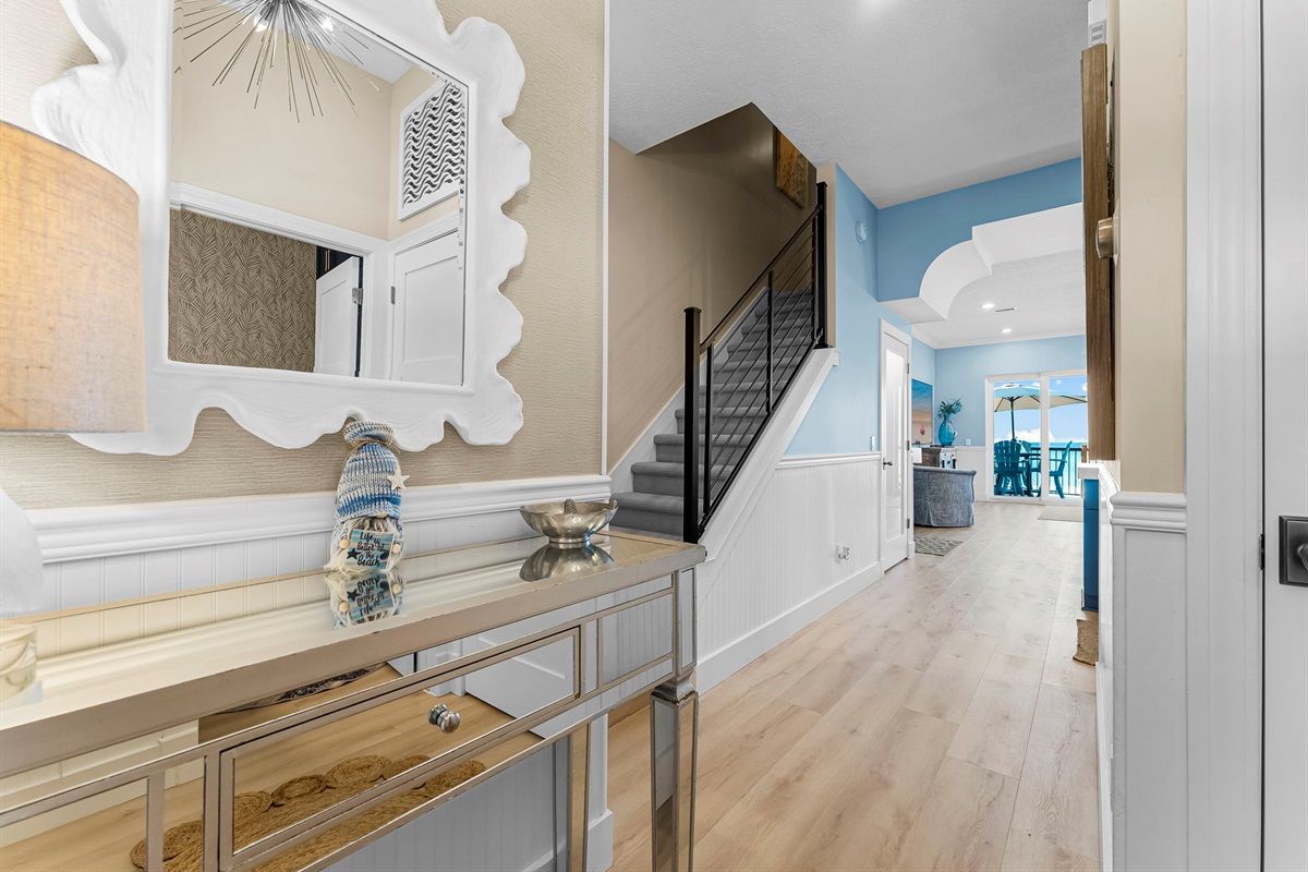 Welcome inside: entry hall with stairs connecting to upper-level bedrooms on the 2nd and 3rd floors.