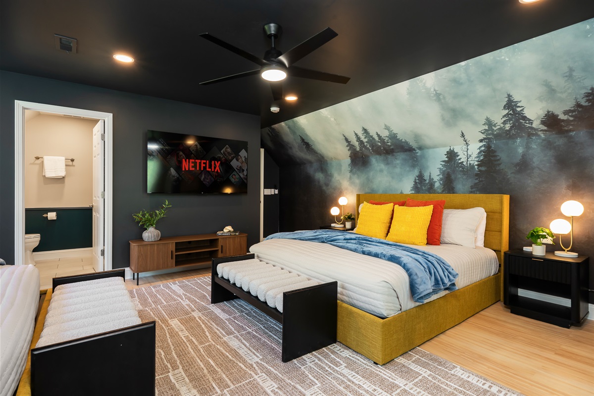 Spacious sleeping area with multiple beds and natural light - comfortable for longer stays