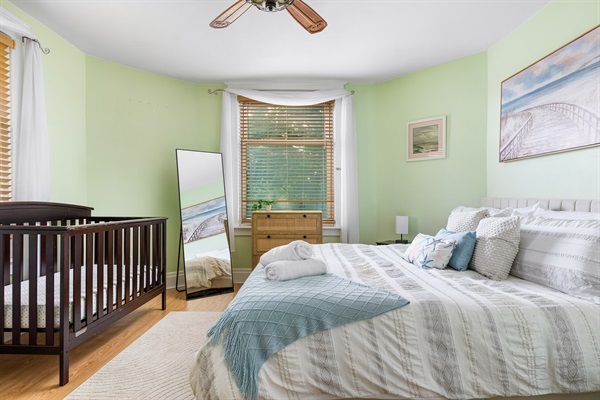 Spacious, cozy bedroom with a fireplace. Stretch out in the queen-sized bed while your little sleeps soundly in the crib.