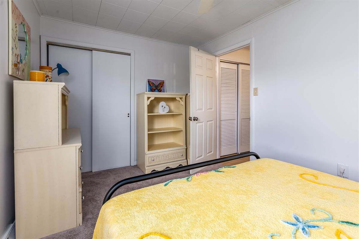 Bedroom 2: With a queen bed, soft lighting, closet space, and dual bookcases (one with drawers), this room has all you need to unwind.