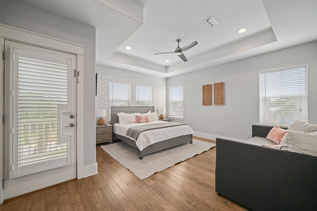 Light-filled Grand Master King Suite offering a spacious layout and private ensuite bath, large walk in closet, and private outdoor balcony.