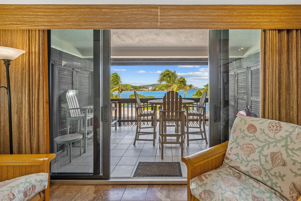Living room opens to the balcony with dining for 4