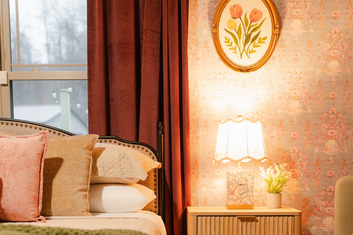 This bedroom features warm touches and a cozy setup designed for comfort.