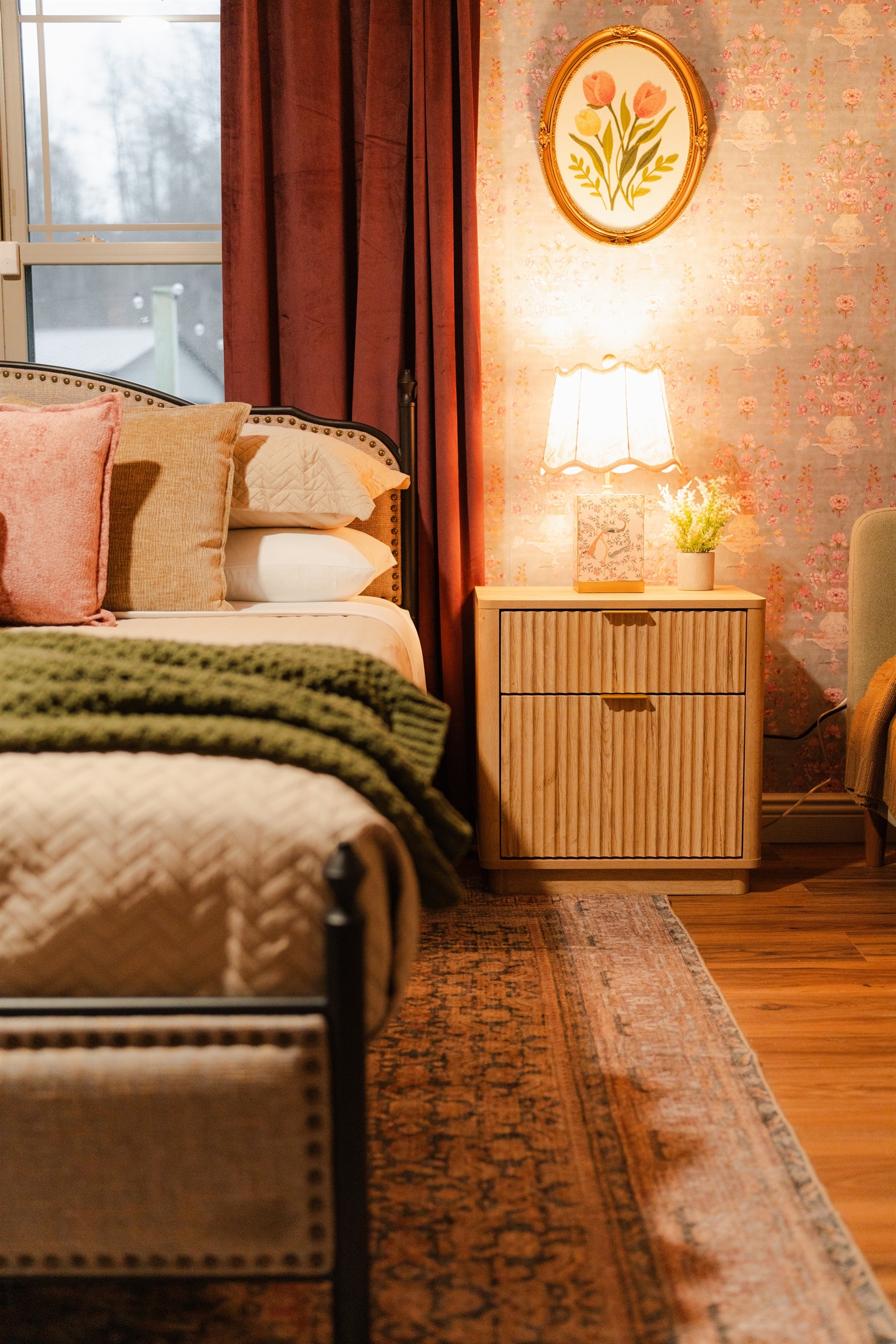 This bedroom features warm touches and a cozy setup designed for comfort.