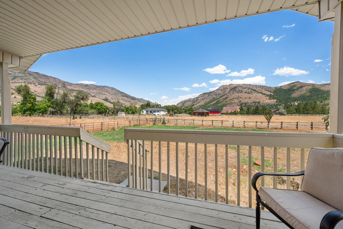 Take in expansive countryside and mountain views from the covered deck, where the open landscape creates a calm and secluded atmosphere.