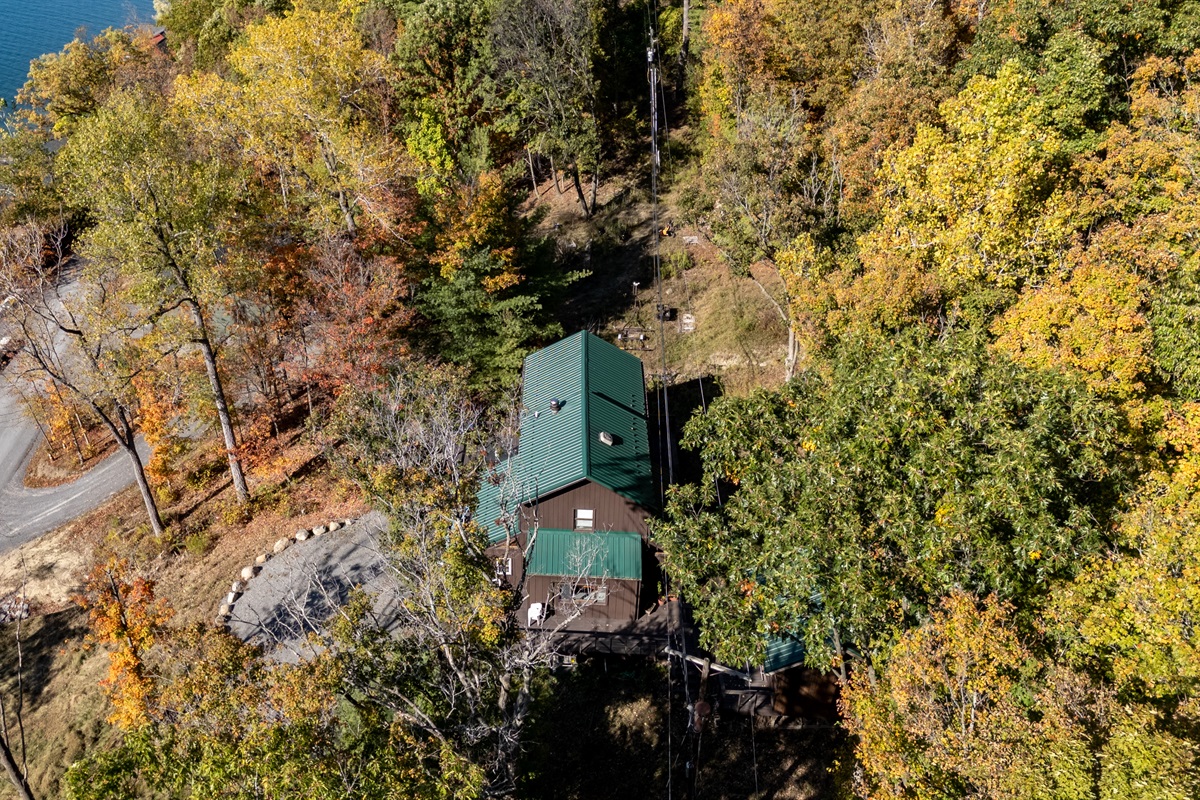 Aerial view of the cabin tucked into the trees above Keuka Lake — your hillside escape.