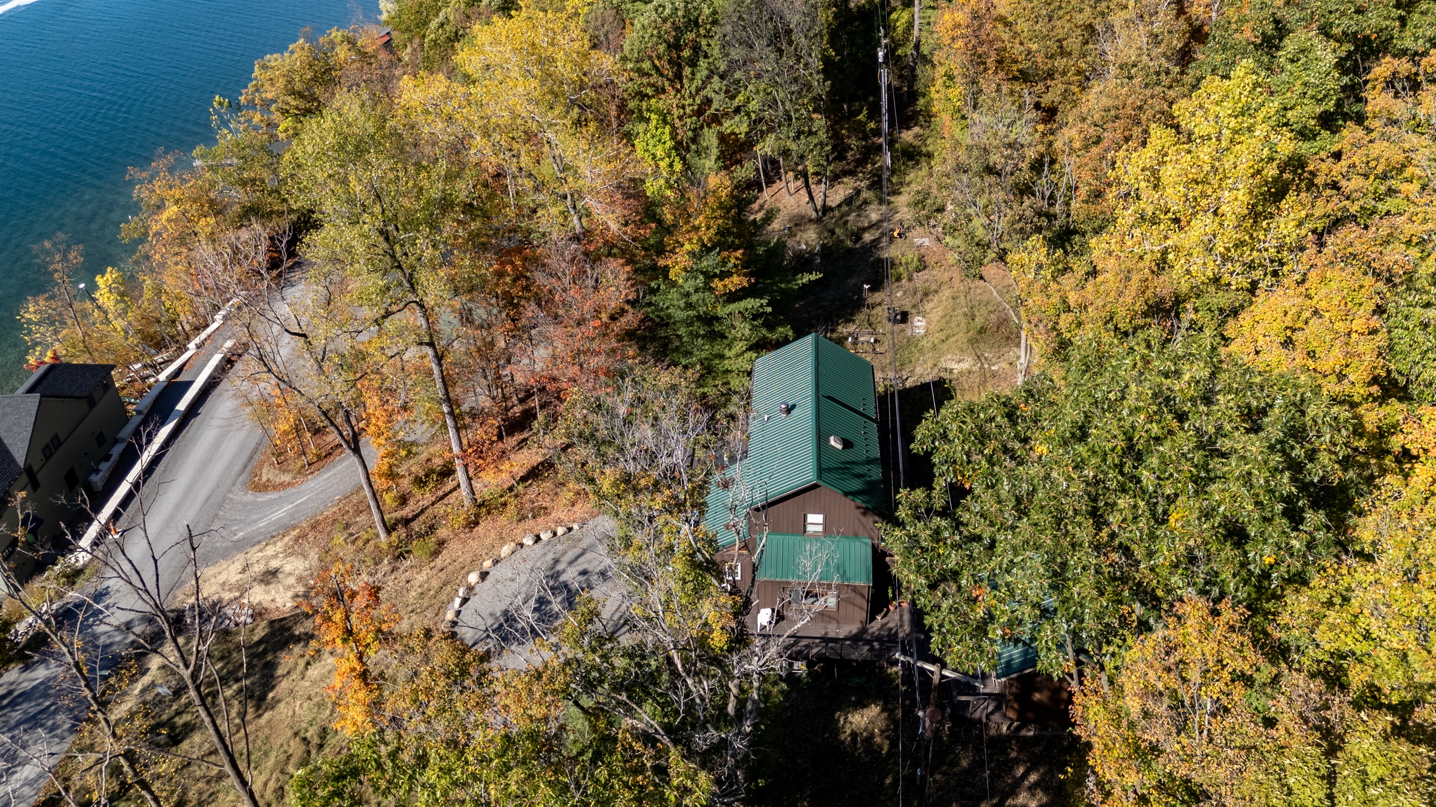 Aerial view of the cabin tucked into the trees above Keuka Lake — your hillside escape.