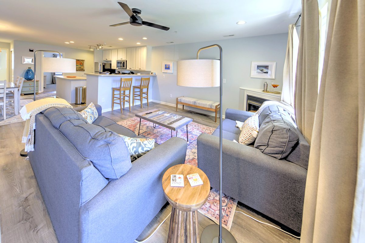 Living Room: Bright and airy space perfect for unwinding after a day at the beach with stylish decor and inviting seating!