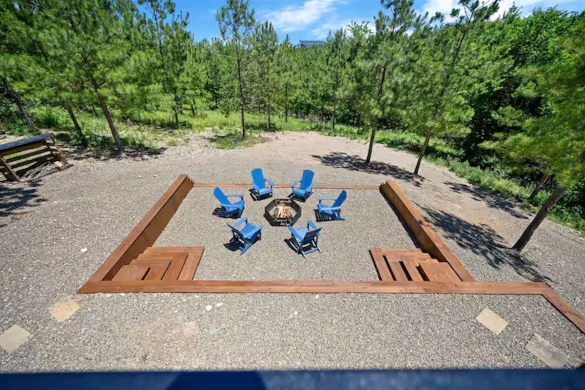 Outdoor fire pit area with Adirondack chairs.