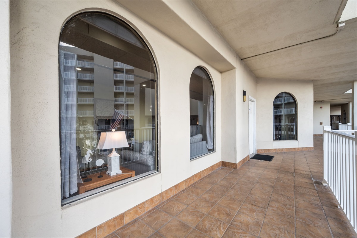 Ground level walkway with arched windows bringing in natural light