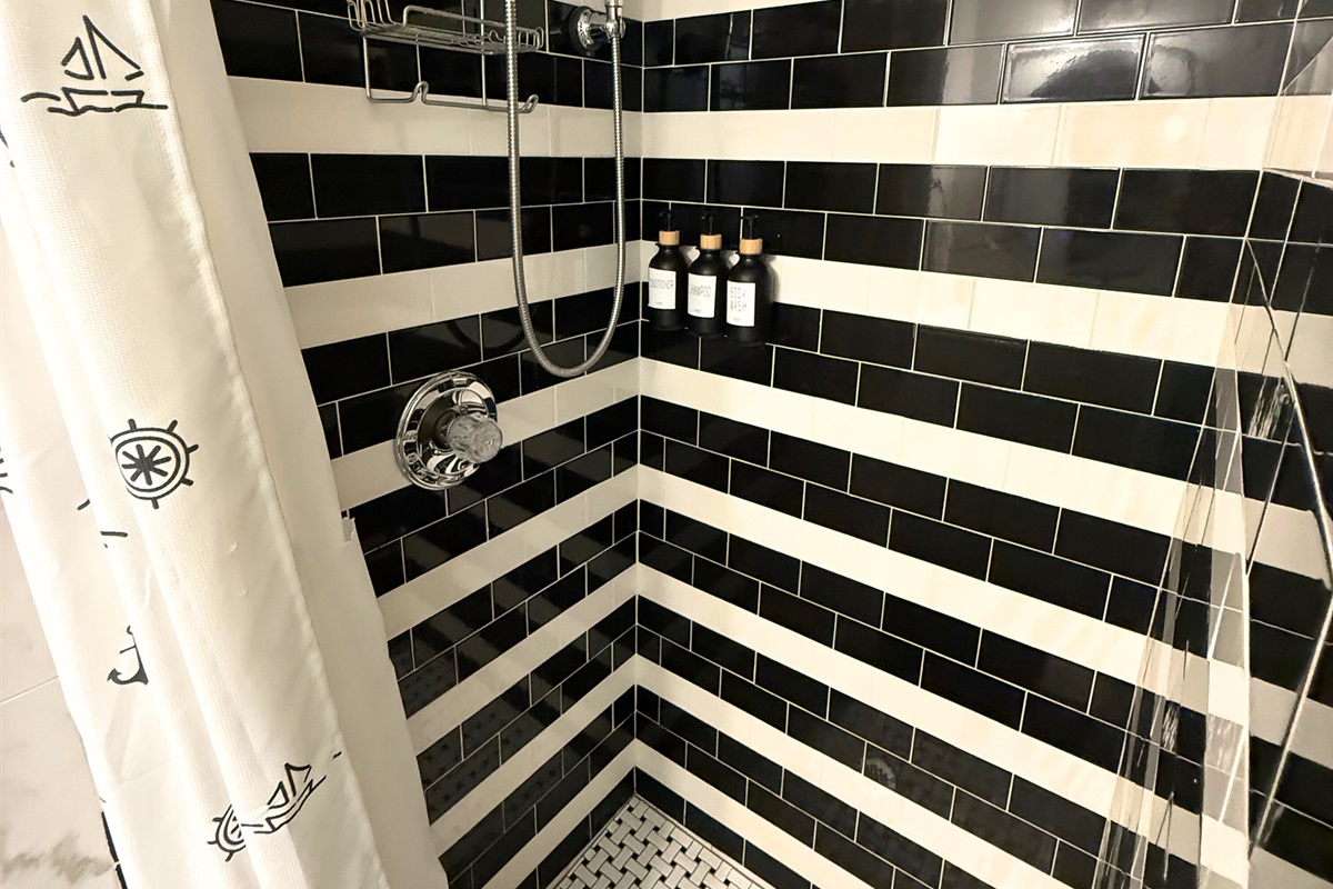 Guest bathroom is down the hall from the two guest rooms