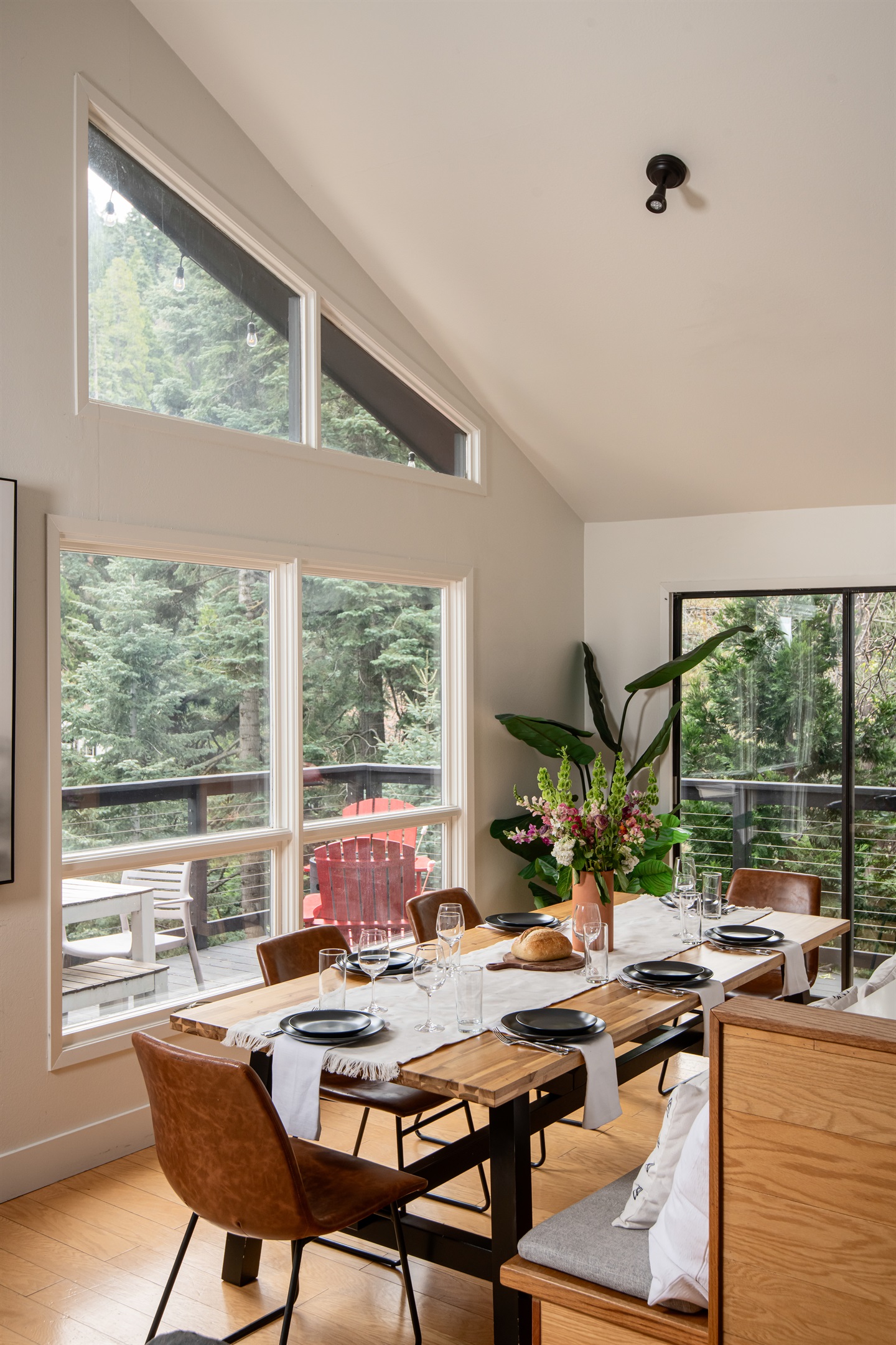 Bright dining area with forest views and large windows—perfect for group meals, morning coffee, and enjoying a peaceful mountain getaway indoors.