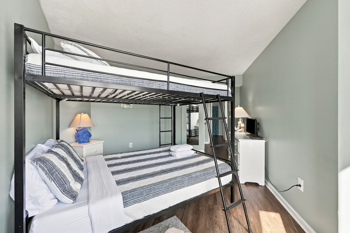 Comfortable metal bunk setup and room to unpack and unwind.