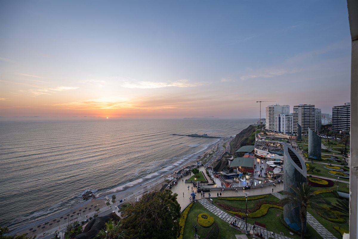 (Photo taken from apartment balcony) View from the living room at evening. World-Class Sunsets: Your private front-row seat to the most magical golden hours in Lima, right from your unique curved balcony