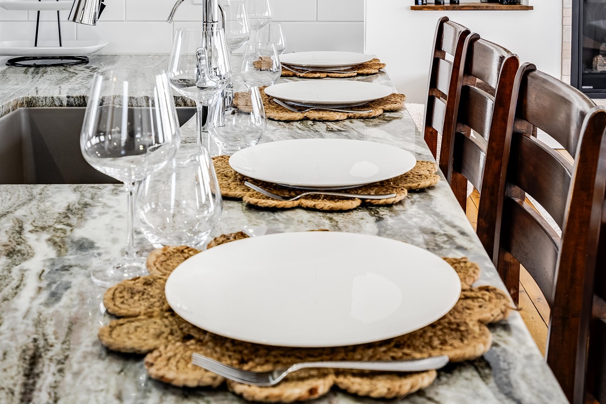  White walls shimmer like morning light, grounded by wood’s steady embrace.