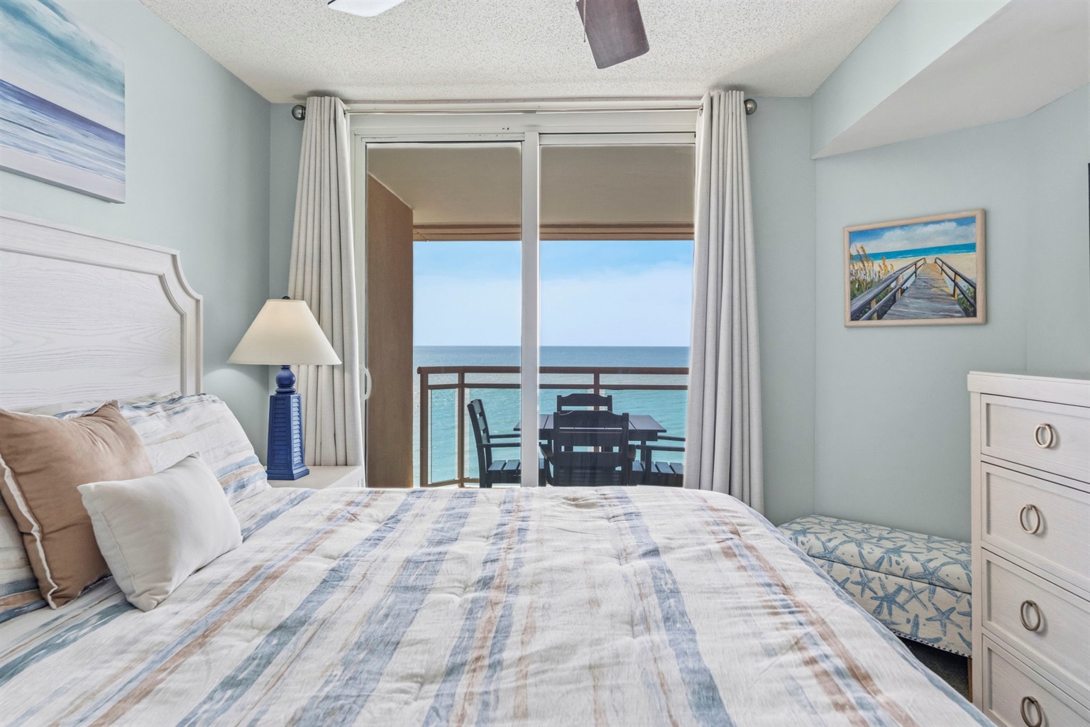 Primary Bedroom with King Bed, ensuite bathroom, and balcony with direct oceanview