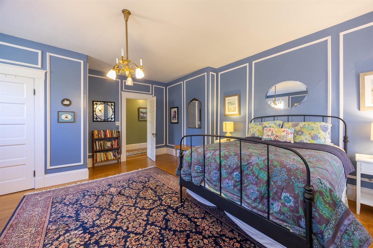 Third bedroom with a queen bed, ample storage, and a peaceful corner to read and relax.
