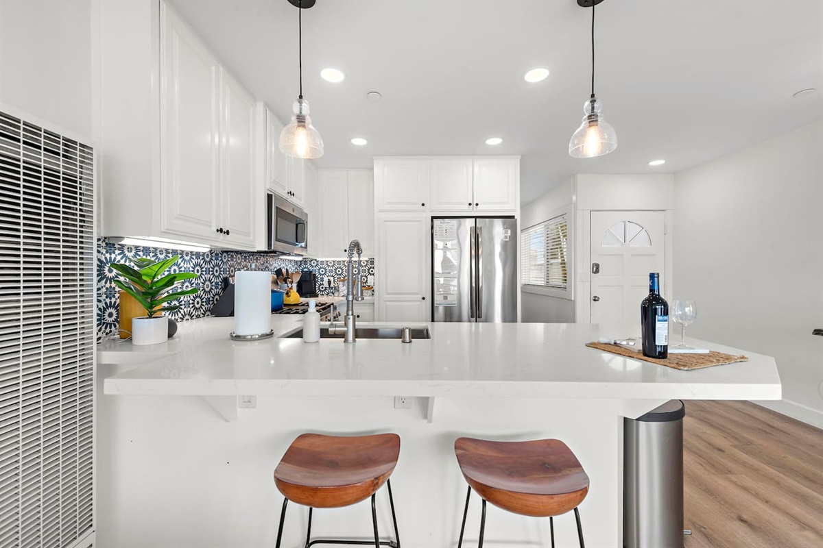 Breakfast bar is a great place to sit and chat with people in kitchen or living room