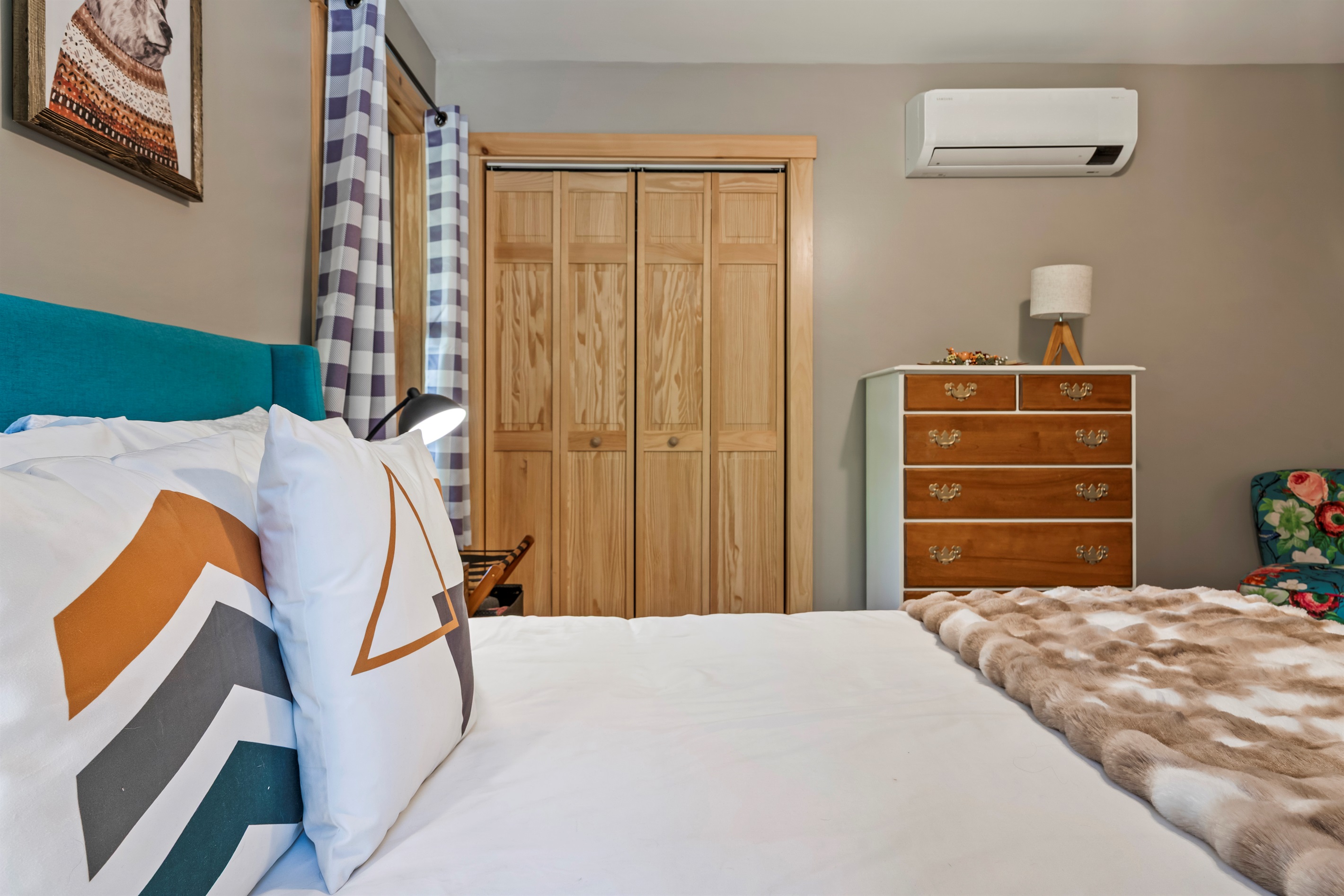 This main-floor bedroom features a queen bed and offers both comfort and convenience