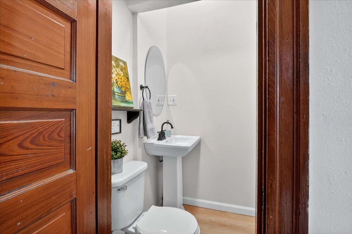 Half bathroom with modern fixtures on the first floor off the kitchen.