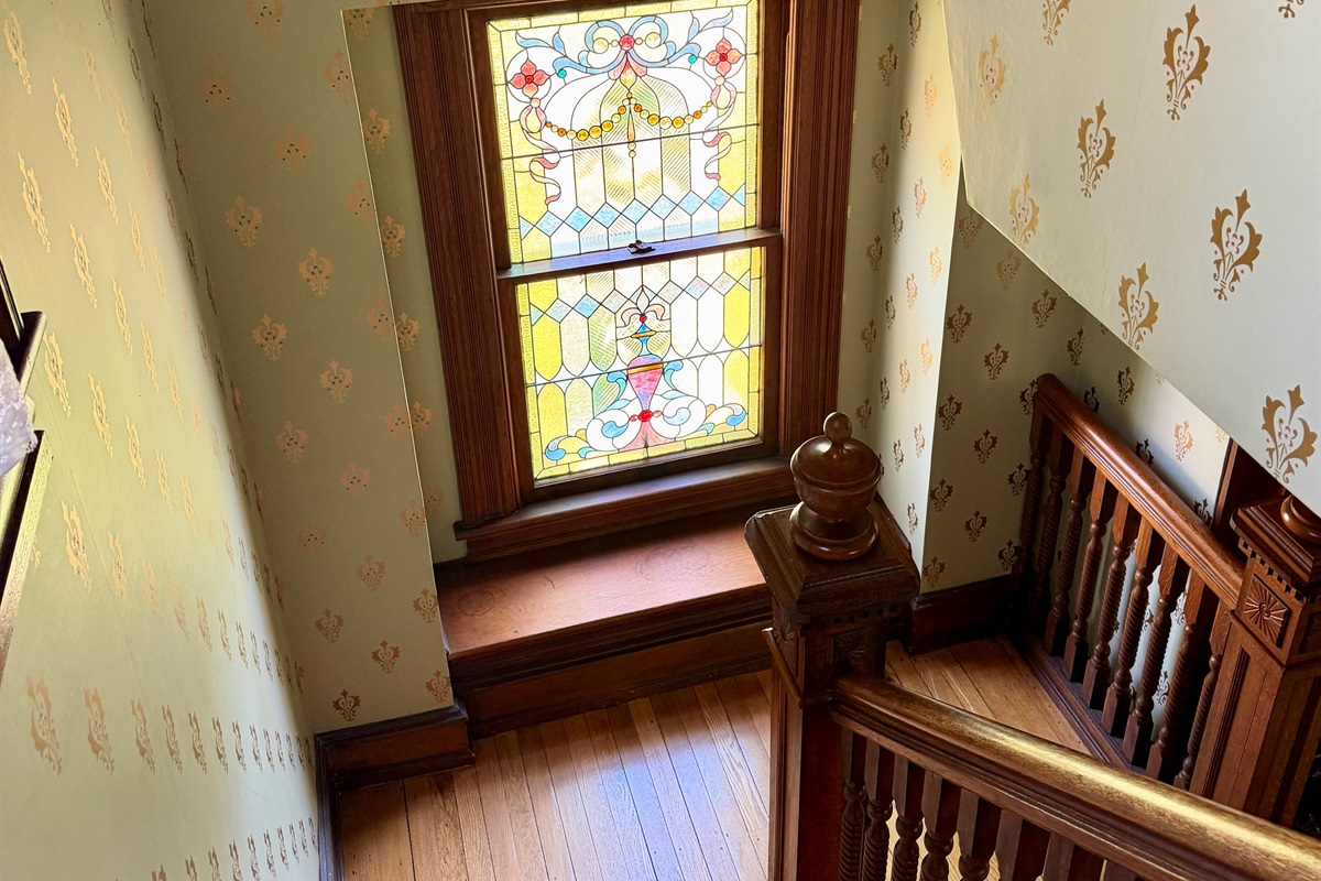 Original Stained glass window filters the light beautifully on the original wood details