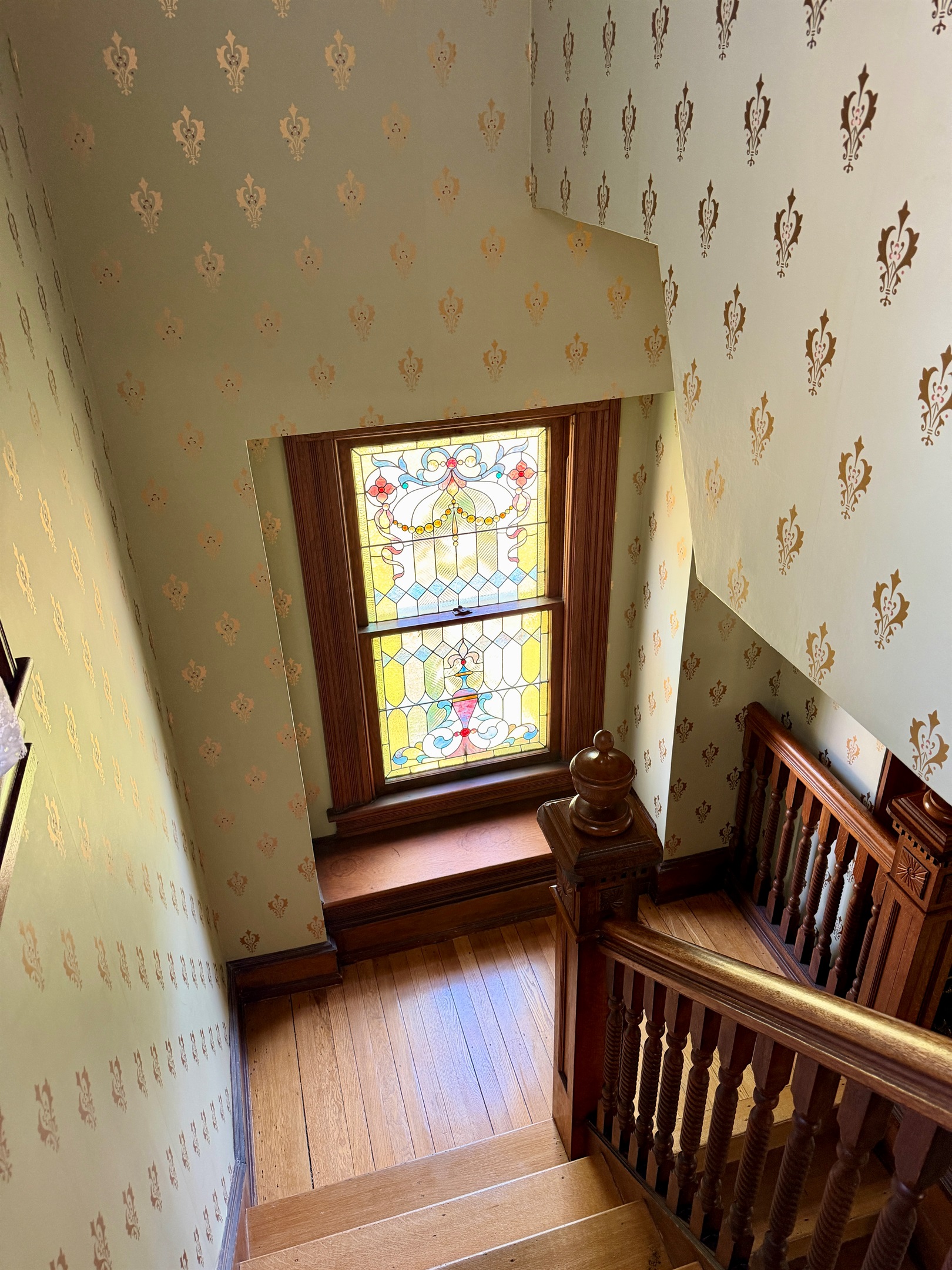 Original Stained glass window filters the light beautifully on the original wood details