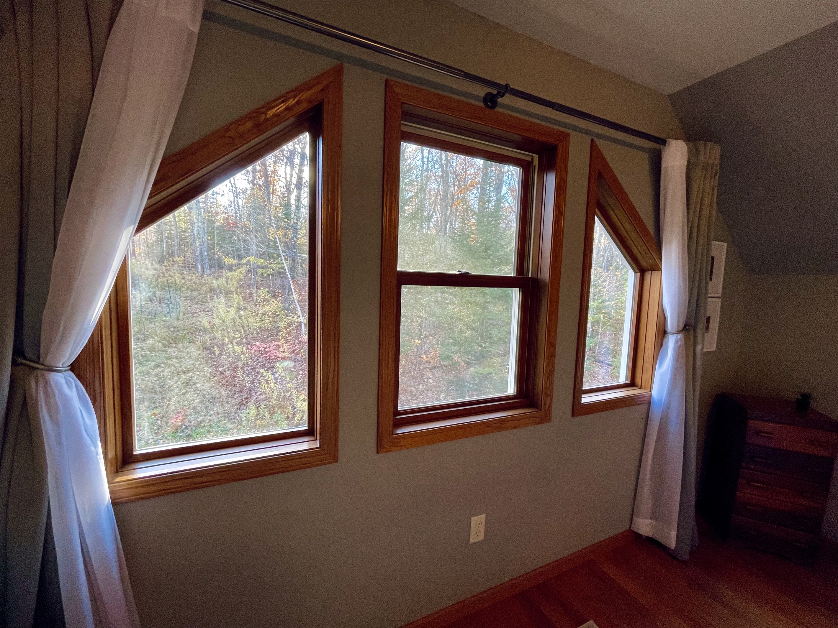 Living room view of the woods out the large 3 windows