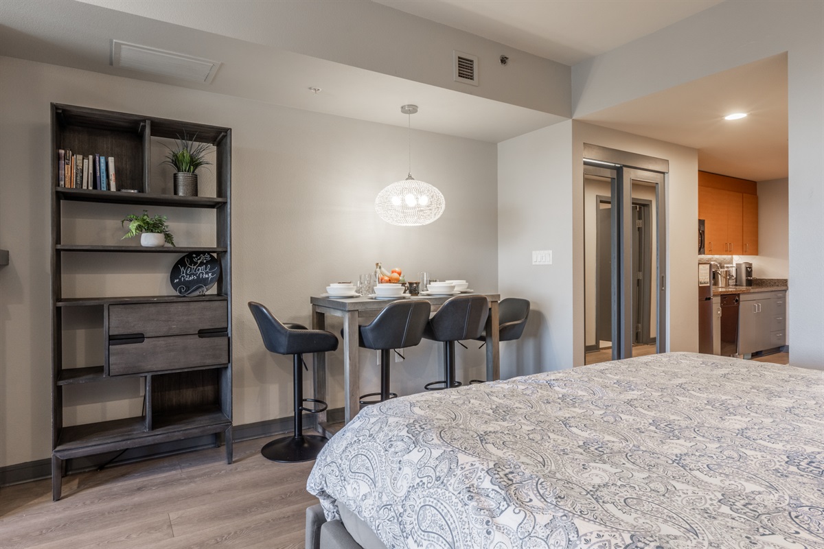 A look at how the sleeping, dining, and kitchen areas connect in the open studio layout.