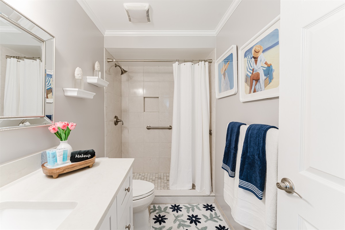 Bright, modern ensuite bathroom with a walk-in shower and clean coastal finishes
