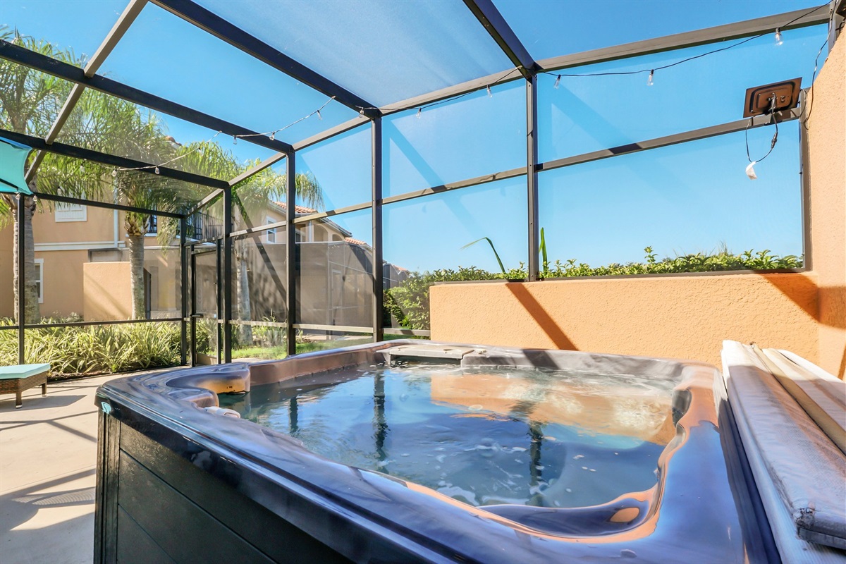 Private covered lanai with lounge area, dining area and hot tub