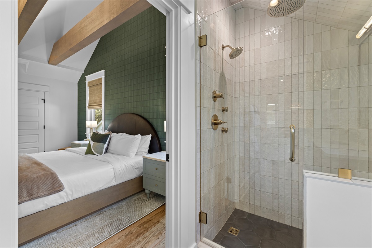 Spa-style bathroom with dual shower heads and body sprays.