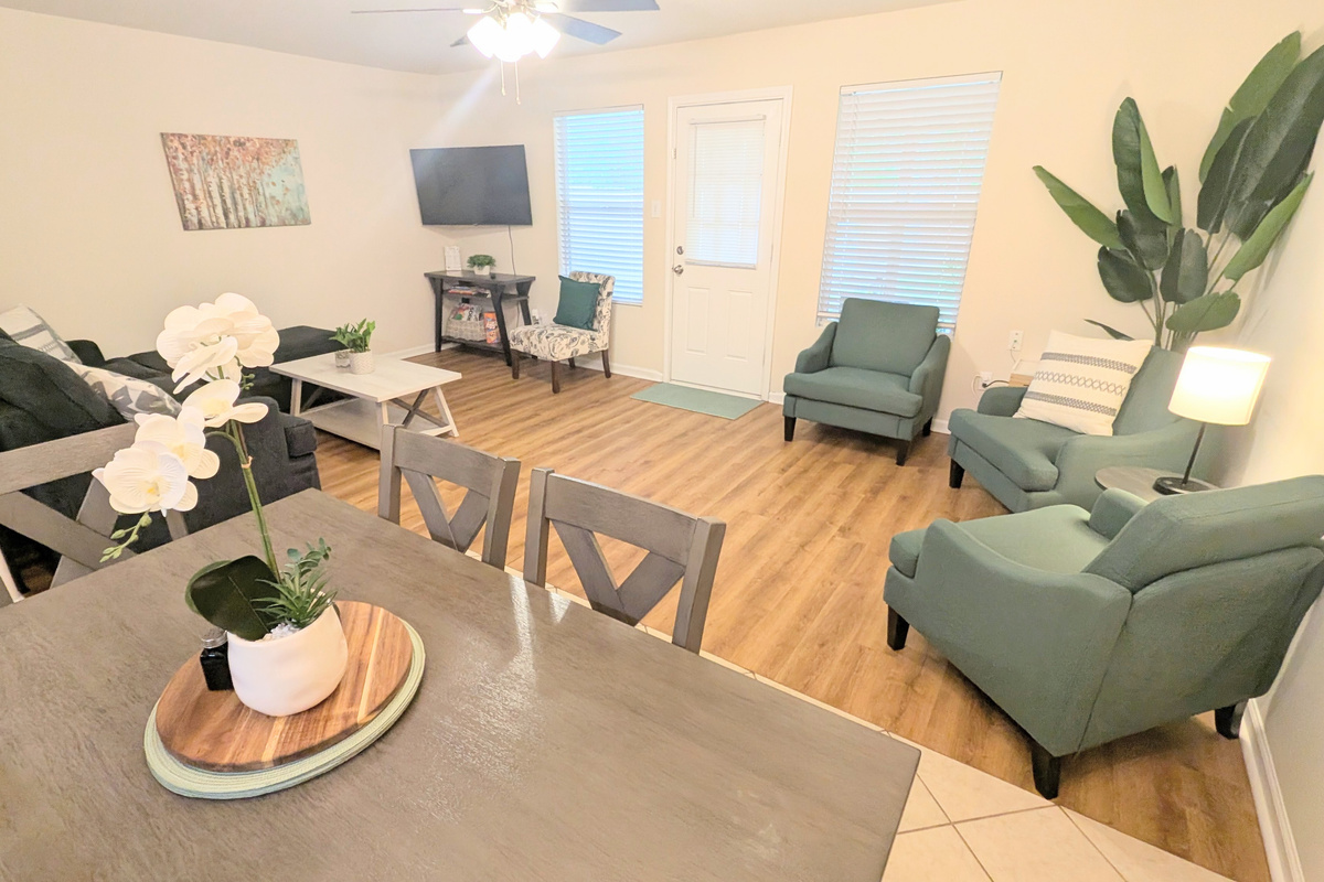 Multiple seating options in this connected dining and living space.