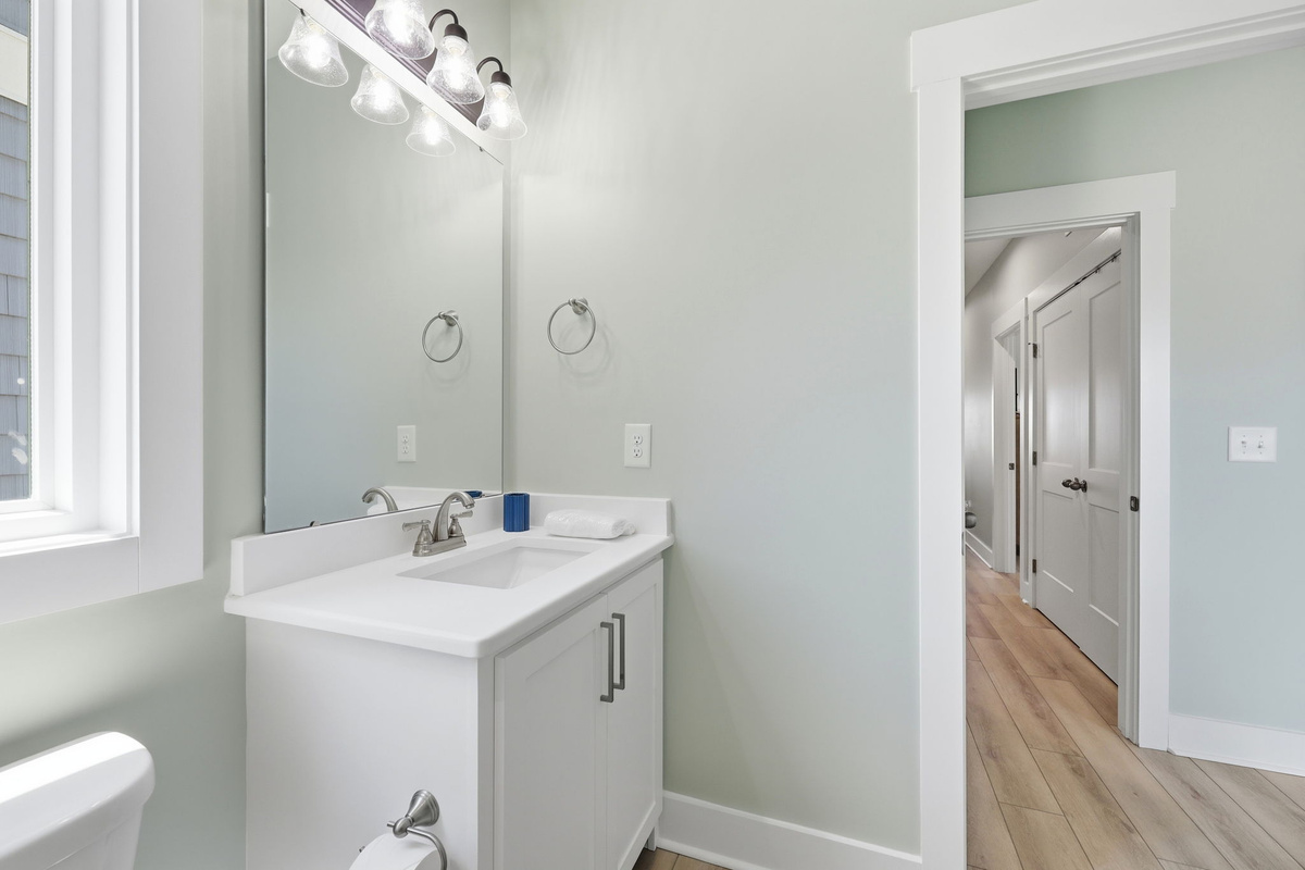 A bright, modern hallway bathroom offers everything guests need for a comfortable stay!