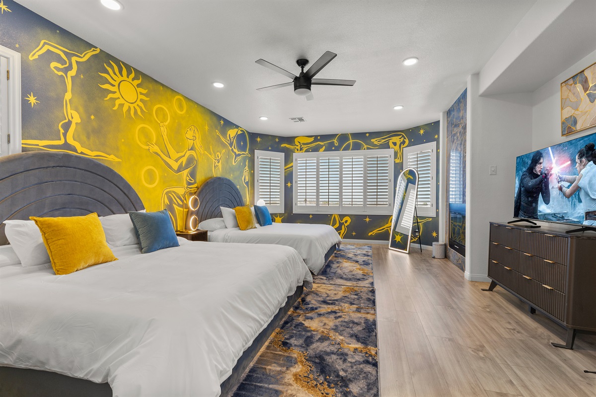 Cirque themed master bedroom with 2 King beds, a gas fireplace, en-suite bathroom, and custom hand-drawn artwork by a local artist.  All bedrooms have a 55" 4K TV.  It’s Showtime!