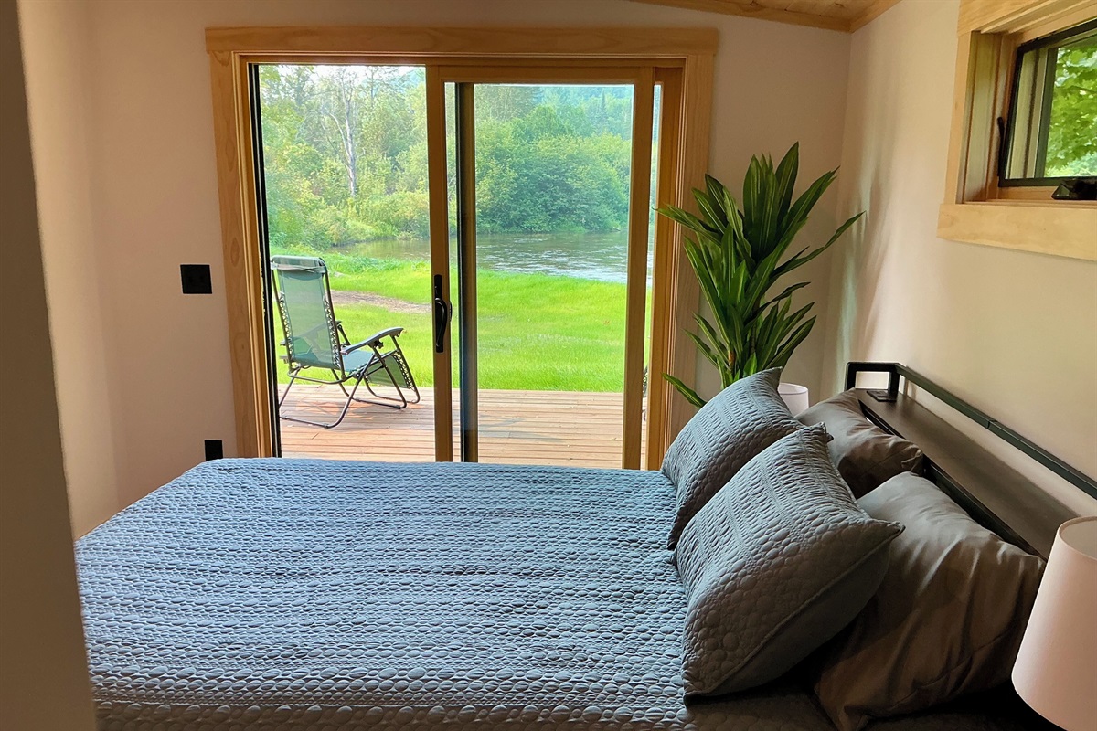 Bedroom has a 65” tv, and remarkable views of the river