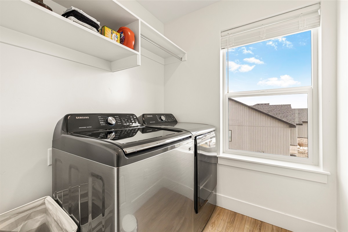 Laundry room with access to washer and dryer.