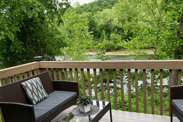Relax on the private deck with cozy seating and a peaceful lake view—perfect for morning coffee or unwinding at sunset.