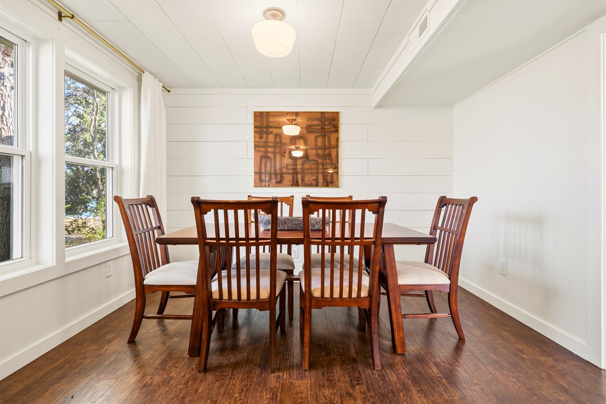 Sit down in the guest house dining area where a cozy table setting creates the perfect spot for shared meals and easy conversation.