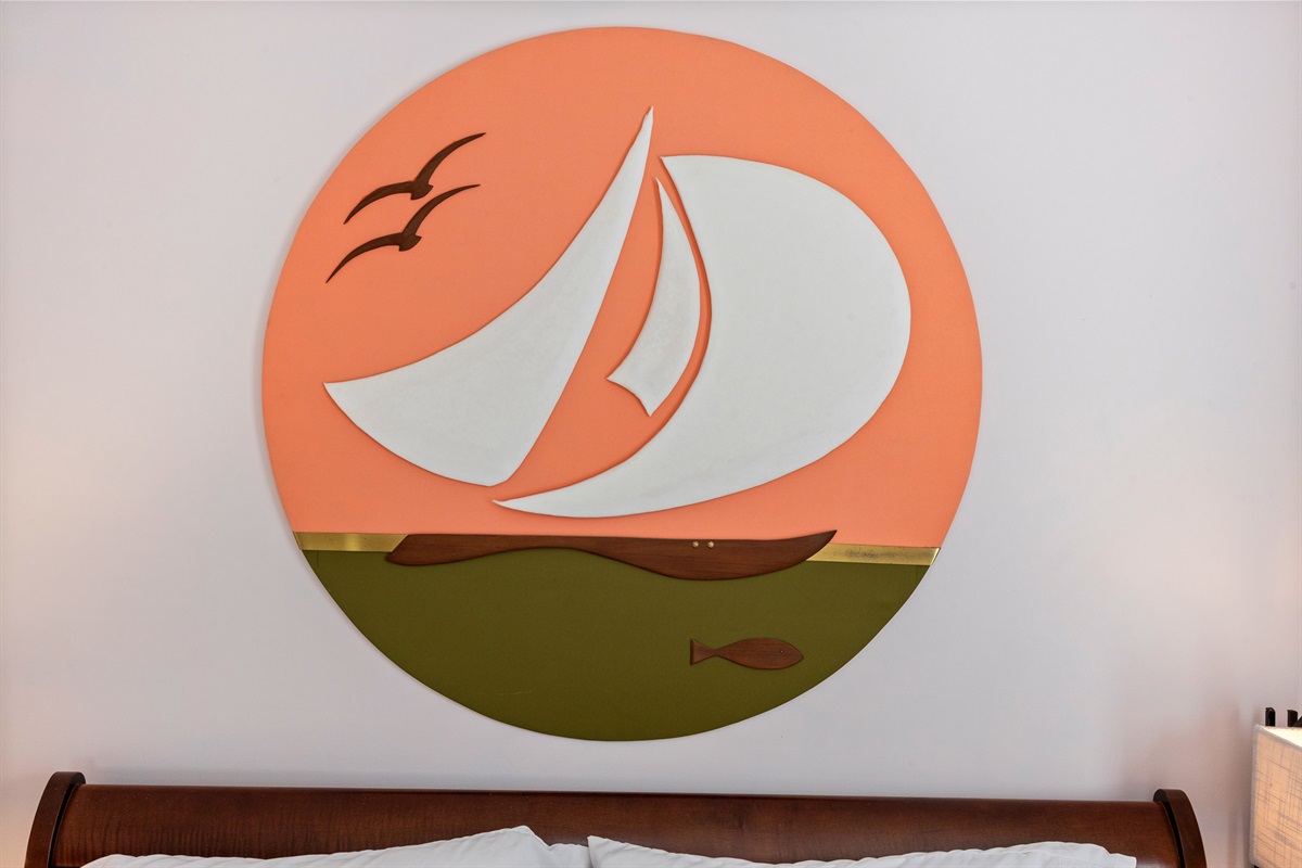 Cozy handmade maritime wall art above the bed.