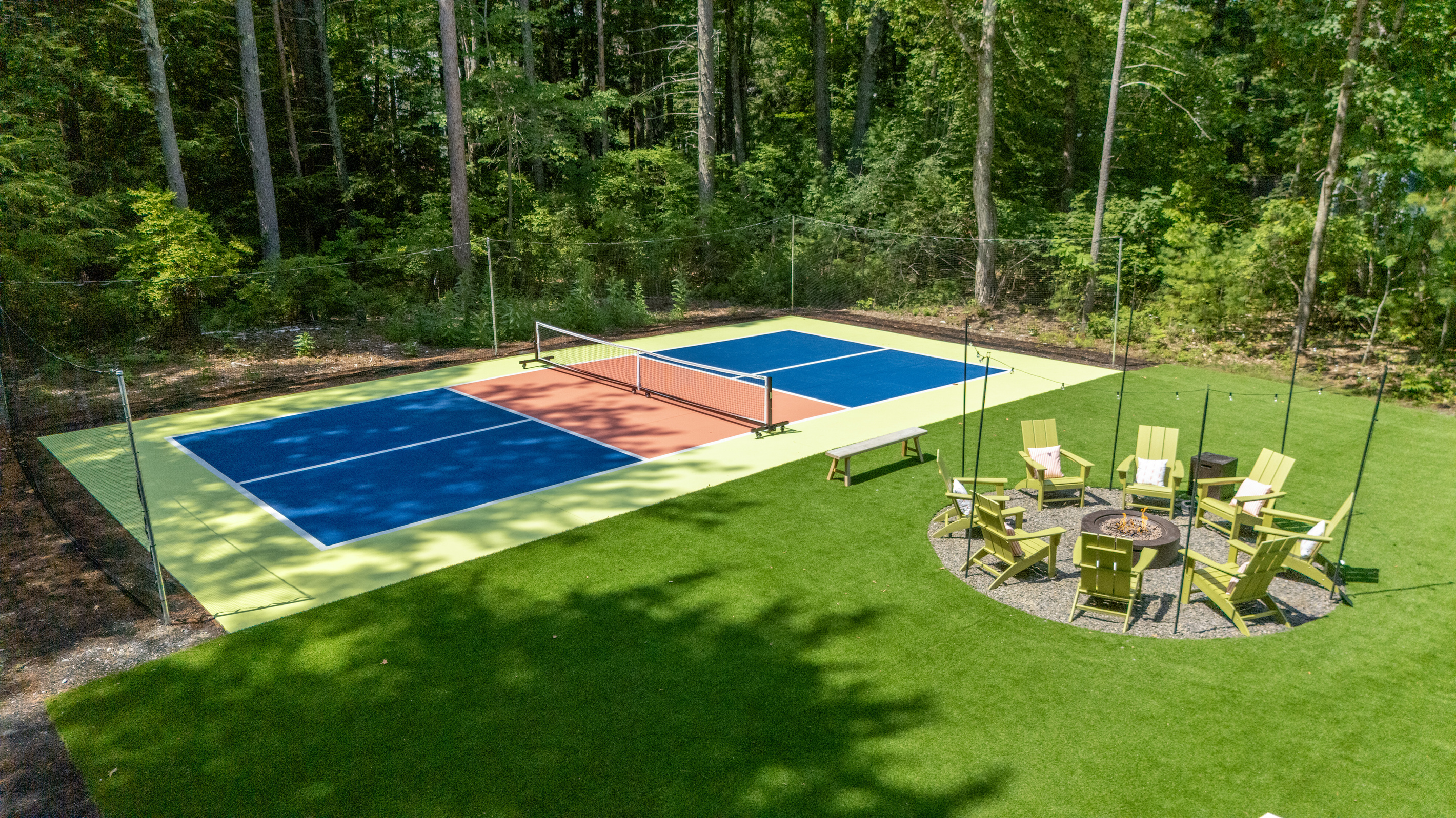 A spacious backyard featuring a Pickleball court, firepit, gatherings, and relaxed time under the open sky.