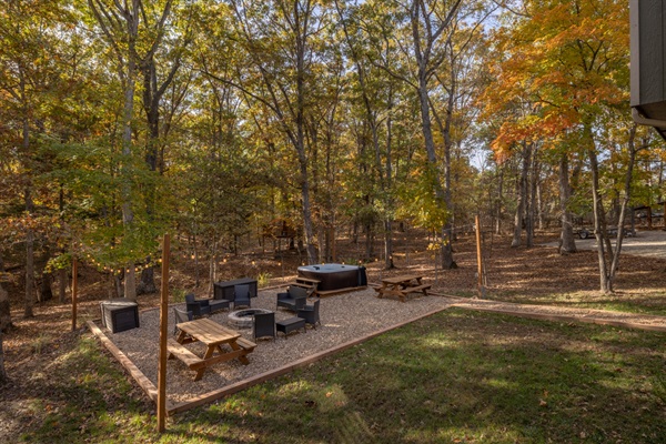 Outdoor area with hot tub, picnic tables, and fire pit
