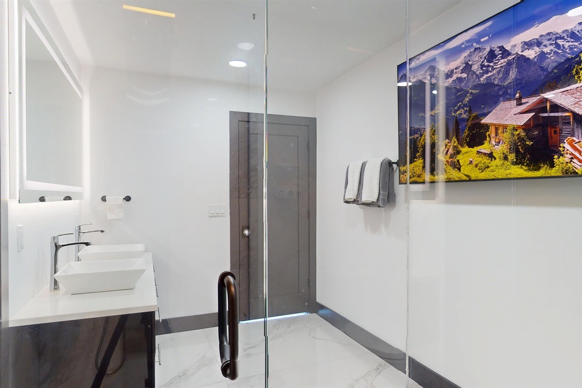 Watch TV while you shower in the main level primary bathroom.