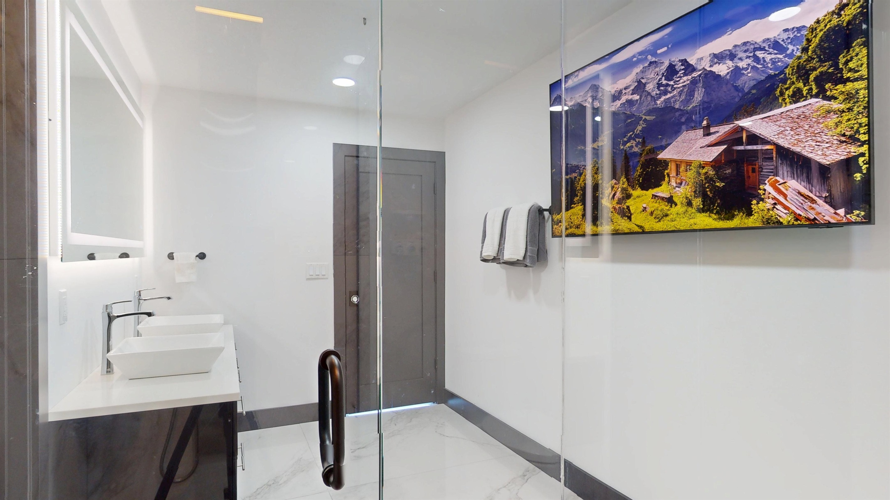 Watch TV while you shower in the main level primary bathroom.