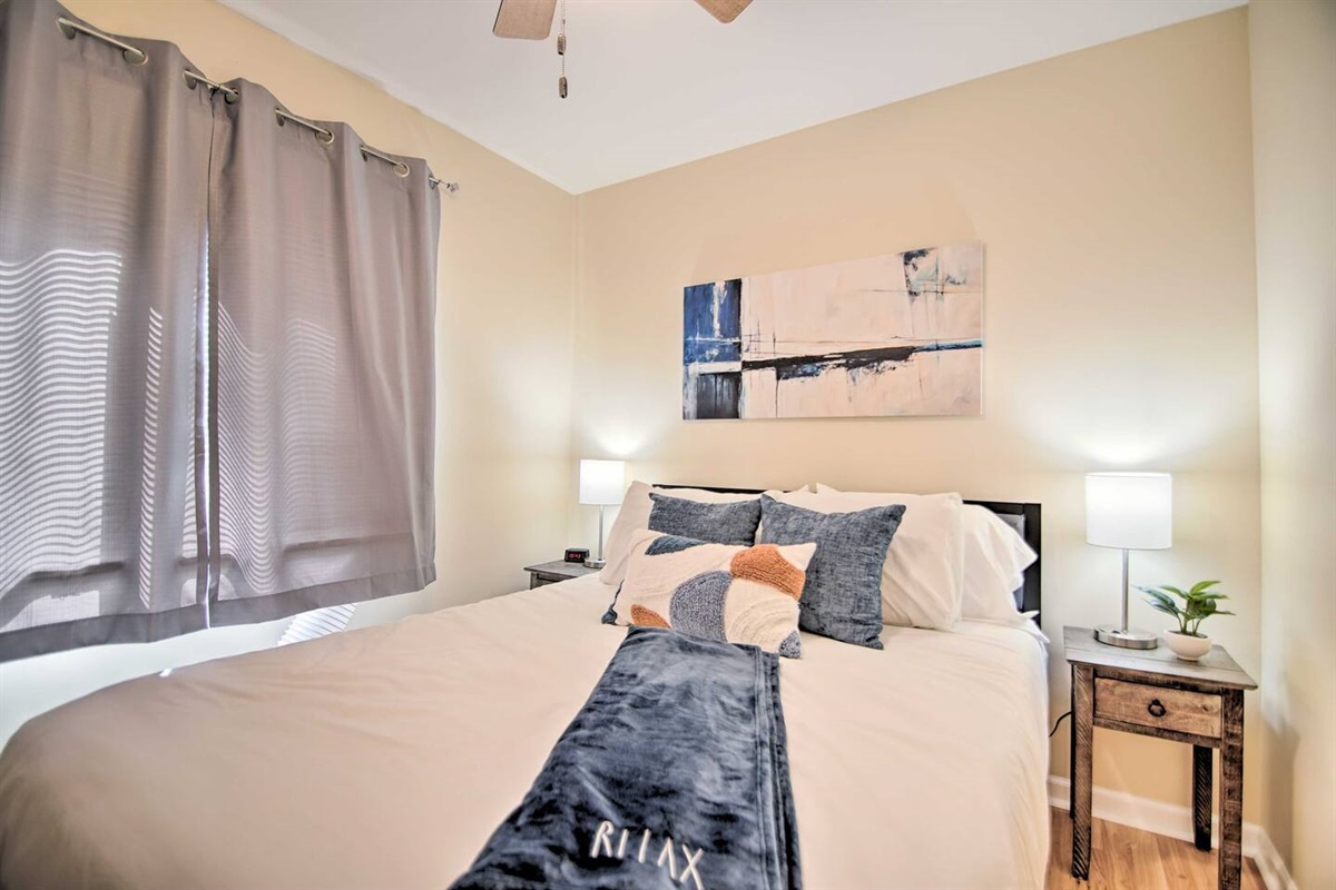 The second bedroom has a queen size bed, window AC, dresser, and a ceiling fan for your comfort. 