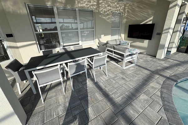 Outside dining for 8, and a sofa area with 65" TV