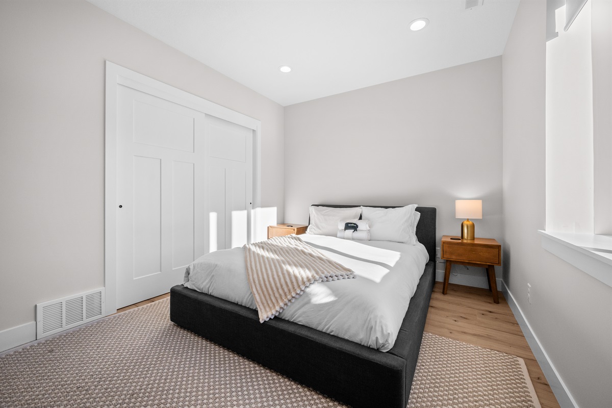 Relaxing Queen retreat with soft lighting and clean, modern design.