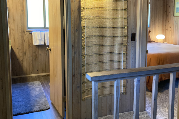 Top of the stairs - looking into the upstairs bathroom and queen bedroom.