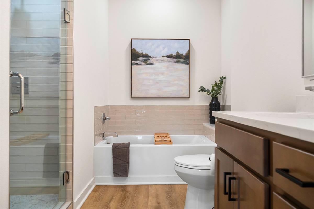 Bathroom 1 features a soaking tub and walk-in shower for a spa-like experience.