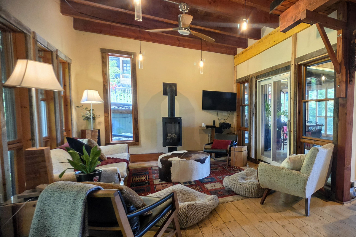 Main cottage living room with stove and smart TV