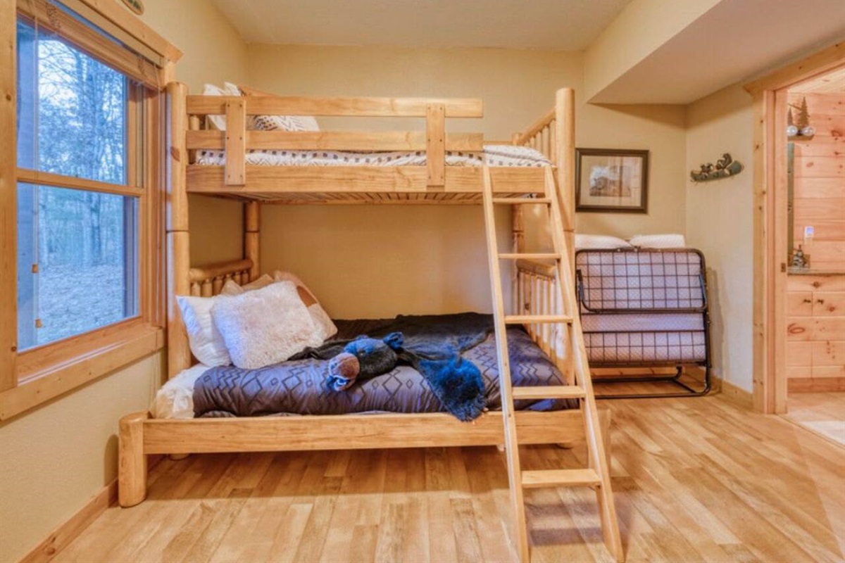 The lower level features a charming bunk room, perfect for cozy nights and shared adventures.